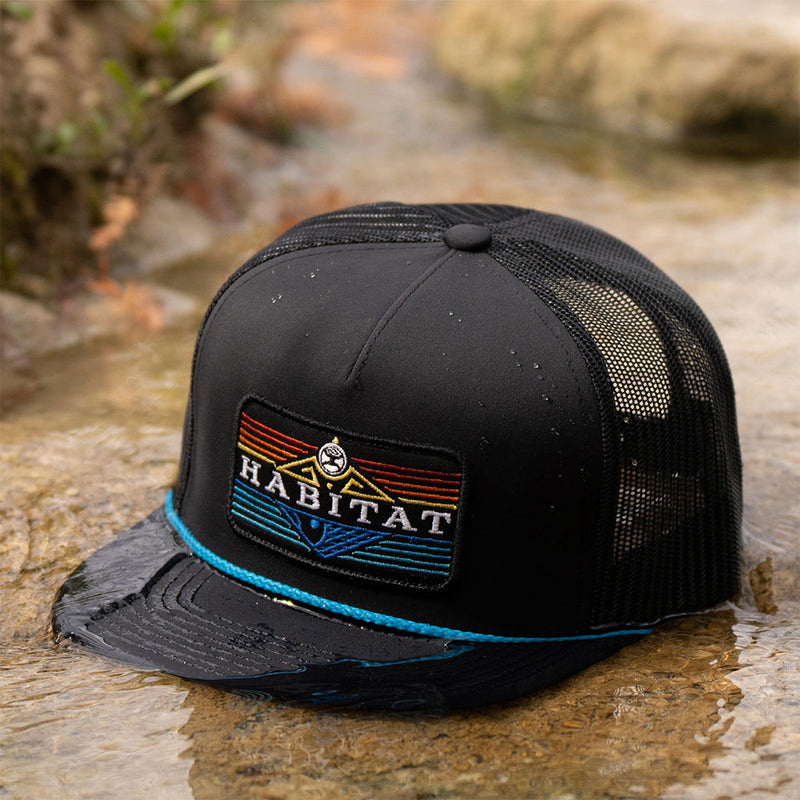 black hat with blue rope detail and multi colored habitat logo patch