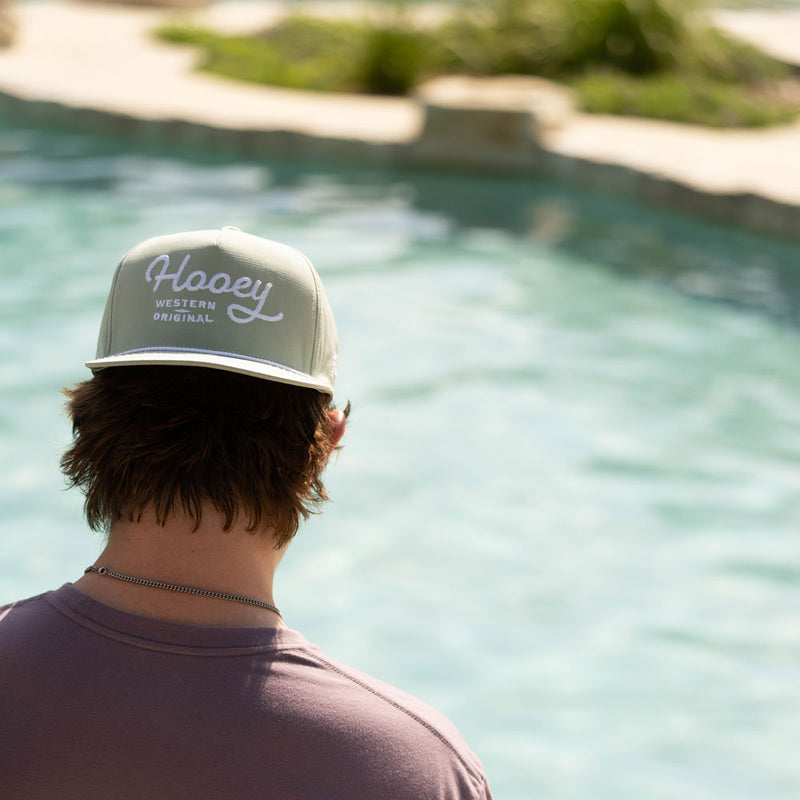 grey hooey original hat worn by male model next to pool
