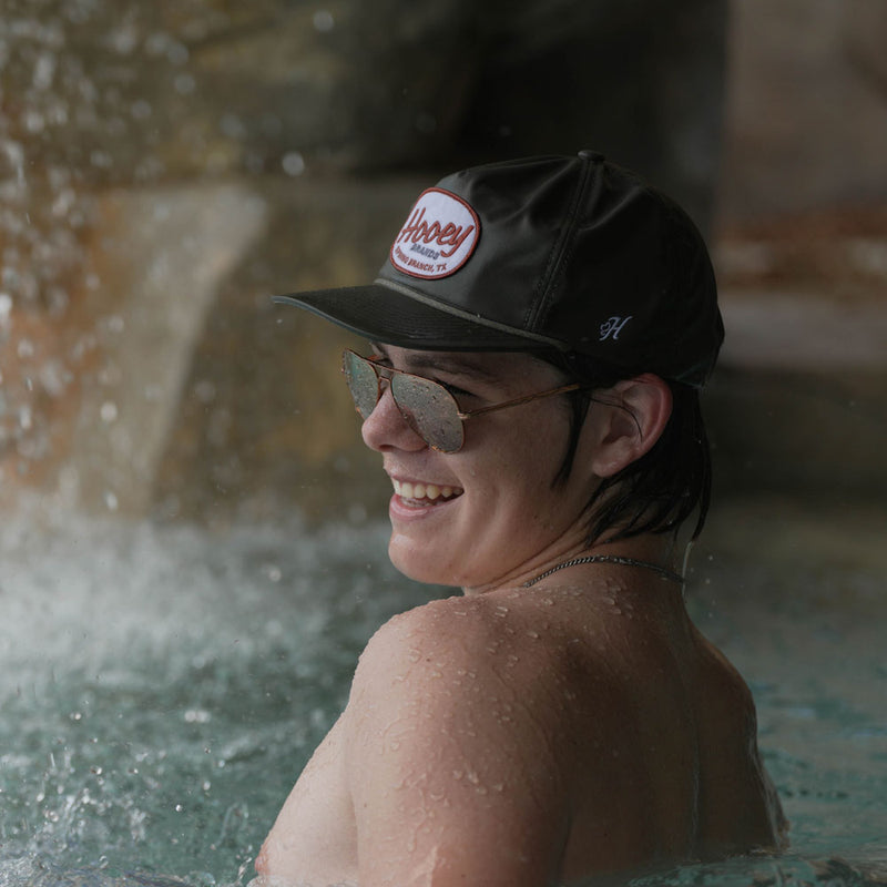 black hooey hat worn by male model in swimming pool 