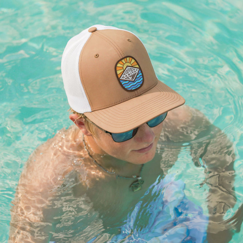 tan and white habitat hat worn by male model