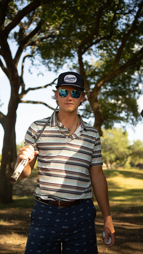 male model posing in golf gear 