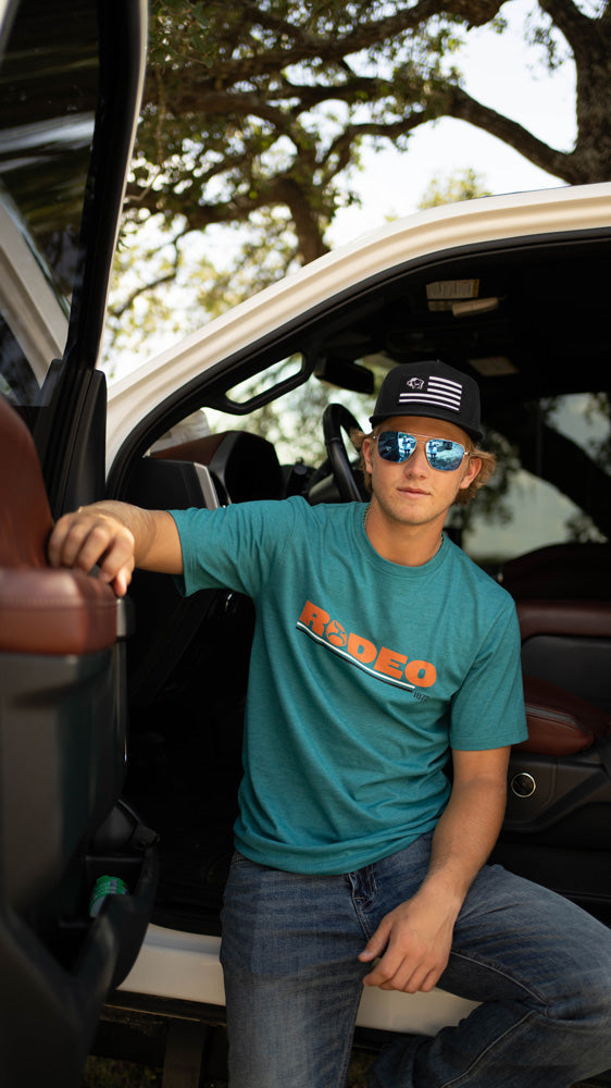 male model posing in door of pick up truck in the latest hooey gear