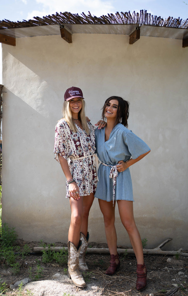 two female models wearing Hooey gear, posing outdoors