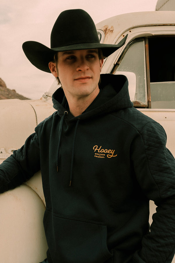 model wearing the canyon navy with gold logo hoody
