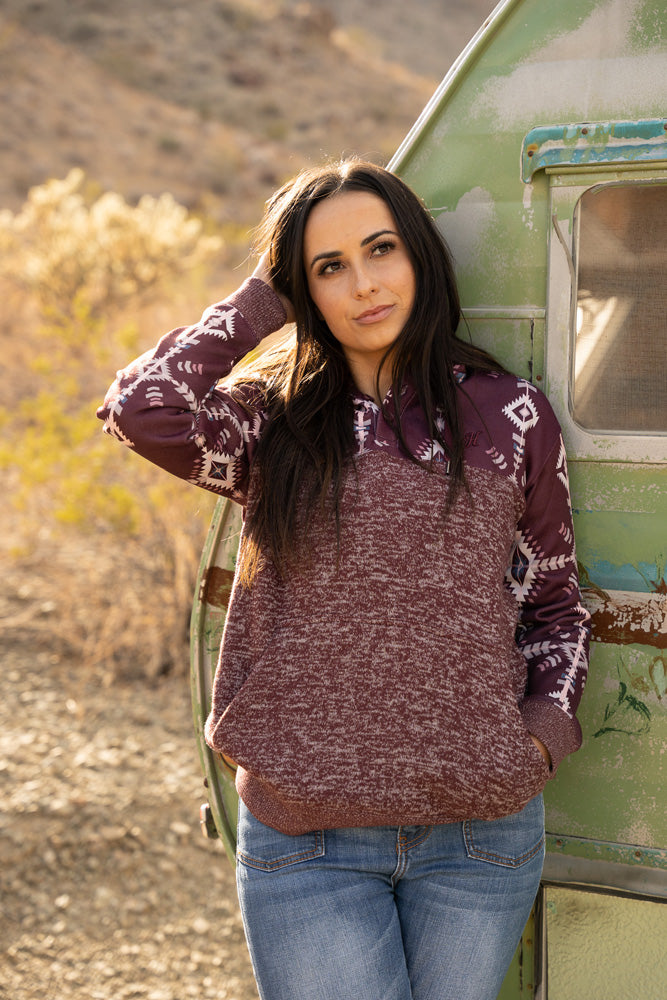 lifestyle image of model wearing the Jimmy charcoal and maroon aztec hoody