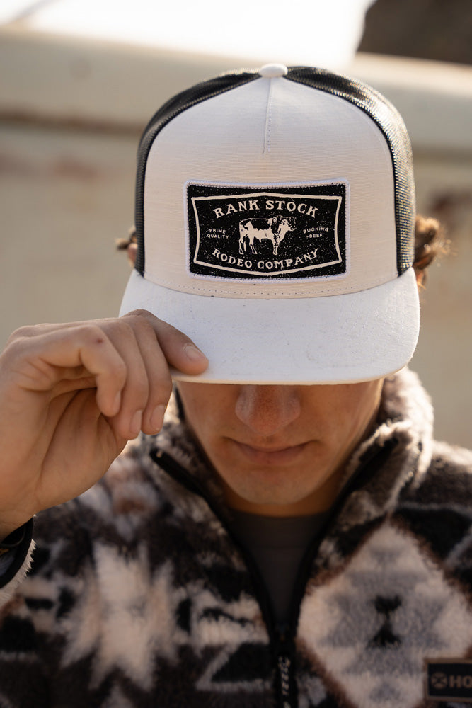white and black rank stock rodeo company hat with black, white, brown aztec pattern pullover