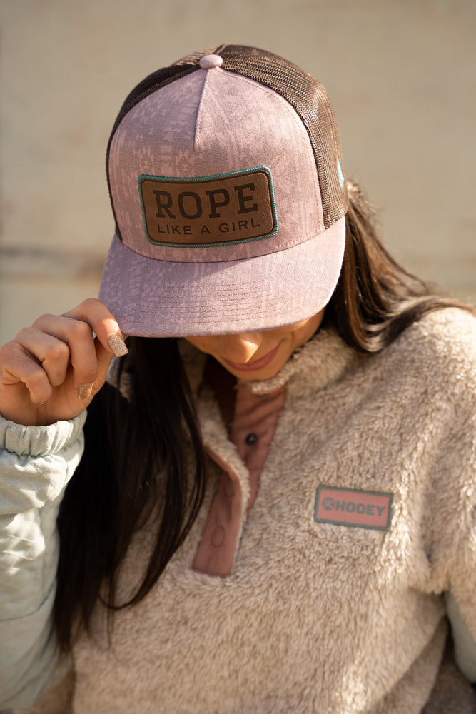 female model wearing pink tone fleece pullover with pink and brown RLAG hat