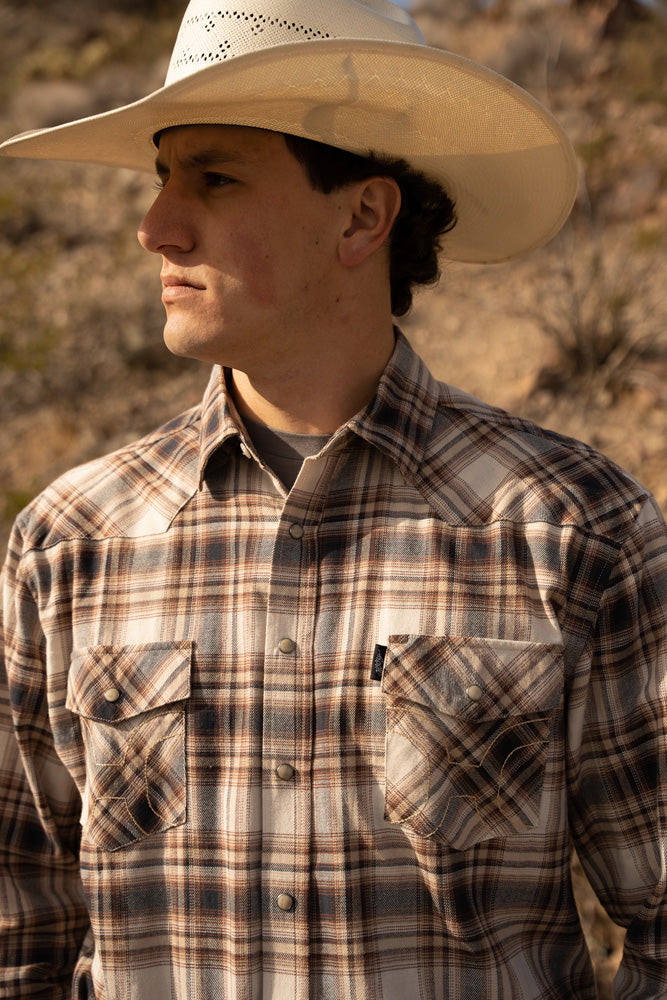 male modeling tan and brown plaid shacket and straw cowboy hat