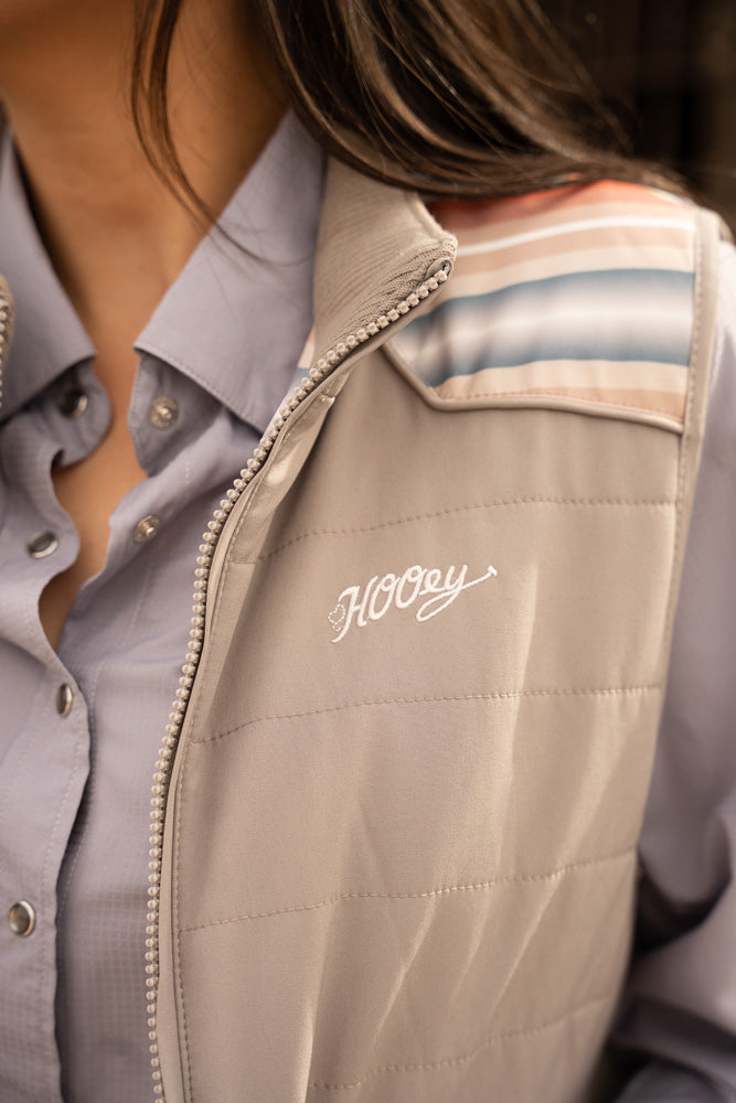 close up of the embroidered hooey logo on tan vest