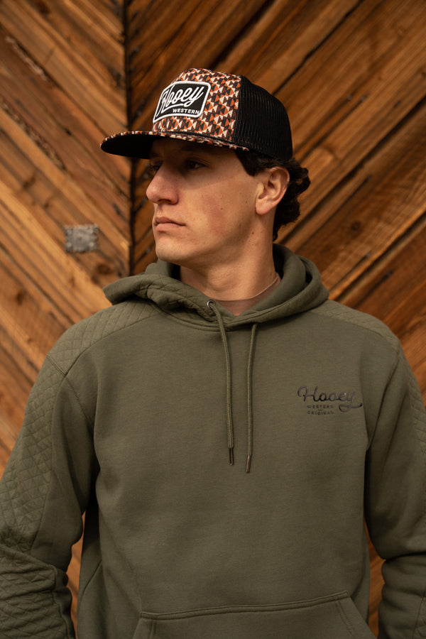 close up image of a model wearing the canyon olive with black logo hoody