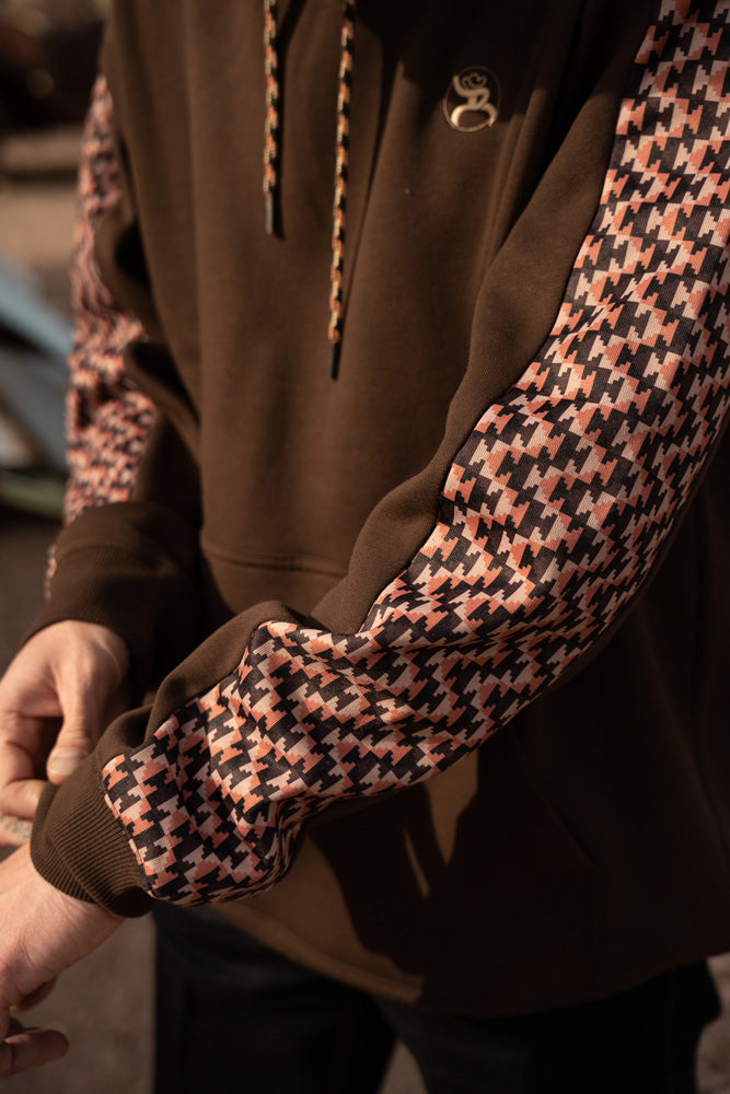 close up of the roughy summit brown with brown and orange pattern hoody