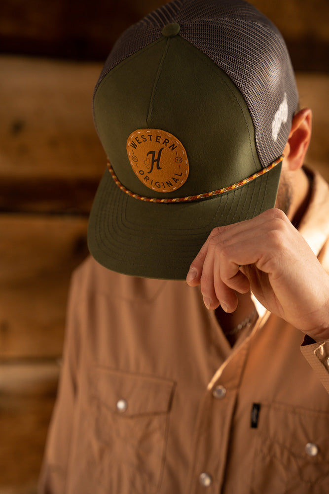 male model wearing tan SOLshirt with olive and grey hooey hat