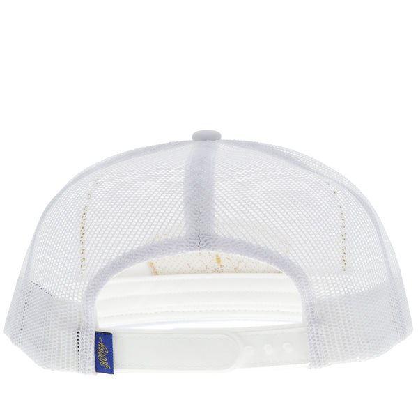 back of white on white Gruene Hall hat with blue and gold patch
