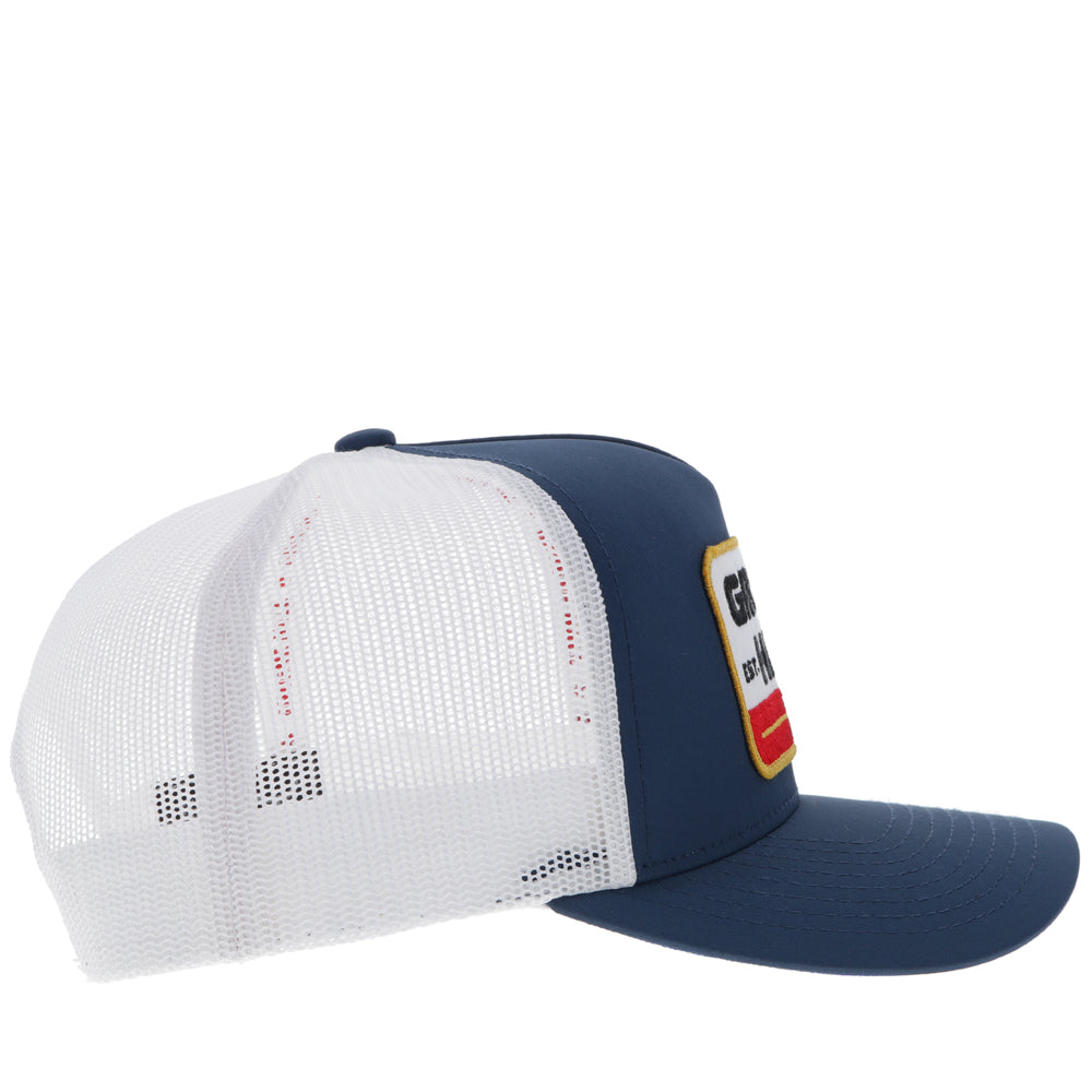 right side of navy and white Gruene Hall x Hooey hat with white, red, gold, black logo patch