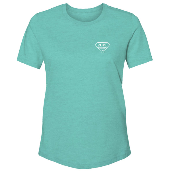 Front of the Bodega heather turquoise shirt with white Rope Like Girl diamond logo on the upper right of the shirt