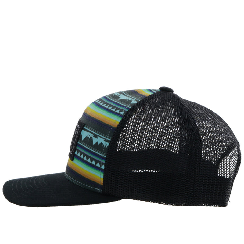 left side of the Doc black hat with yellow, blue, teal, and black Aztec pattern on front