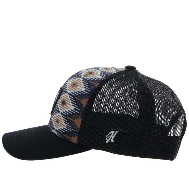 left side view of the black, tan, cream Aztec print hat with white H logo stitching 