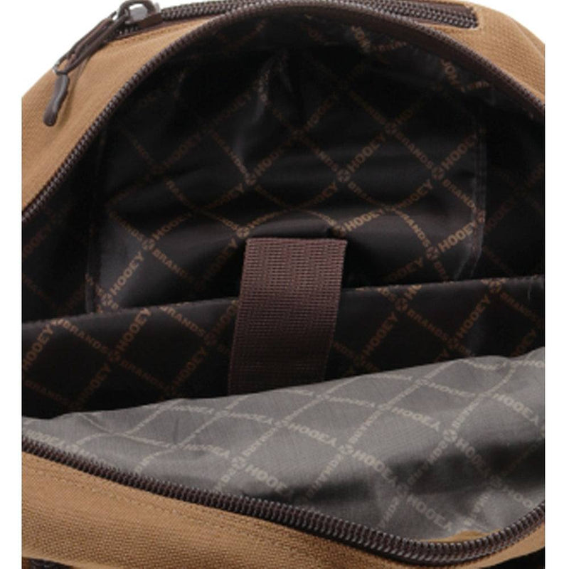 the interior lining of the Mule tan and brown backpack featuring a black base with brown hooey logos in a criss cross pattern throughout