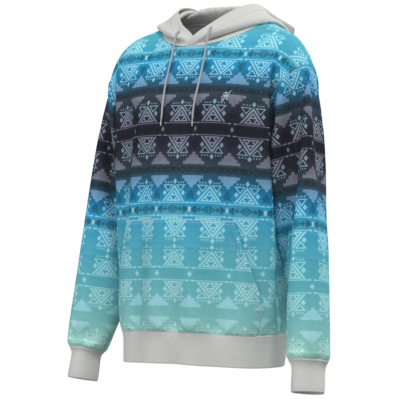 profile view of the Mesa hoody in gradient blue with white aztec pattern, cuffs, and hood