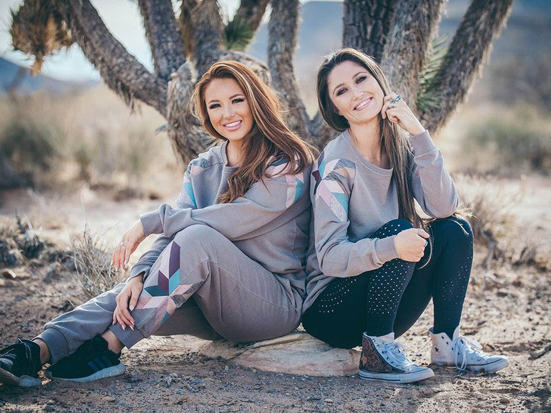 Two female models wearing the Homey Jogger Brown set in a desert setting