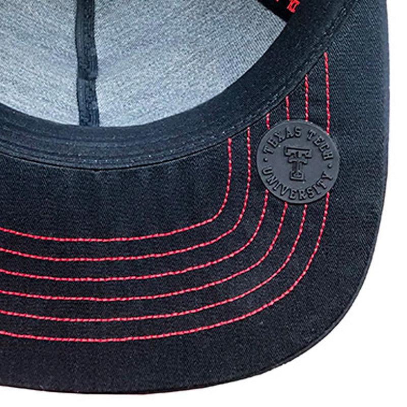 close up of the youth Texas Tech black hat rubber seal on. hat with red raiders logo patch