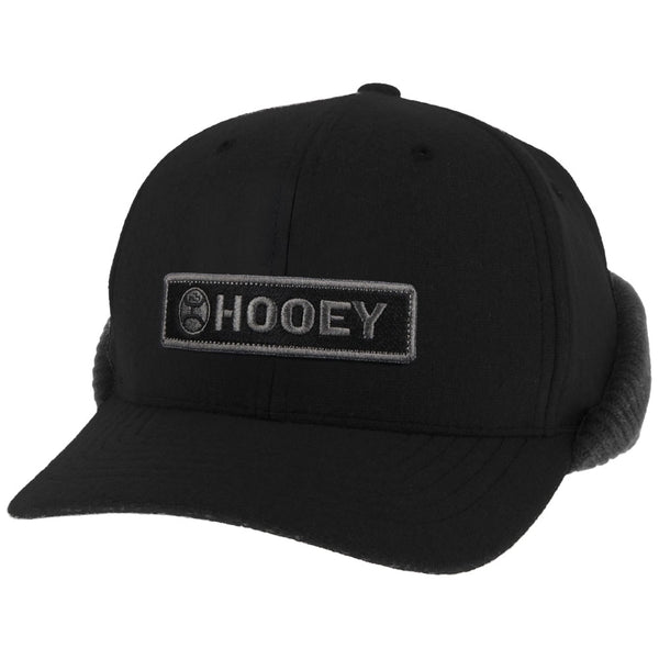 profile view of the black Hooey hat with ear cover attached