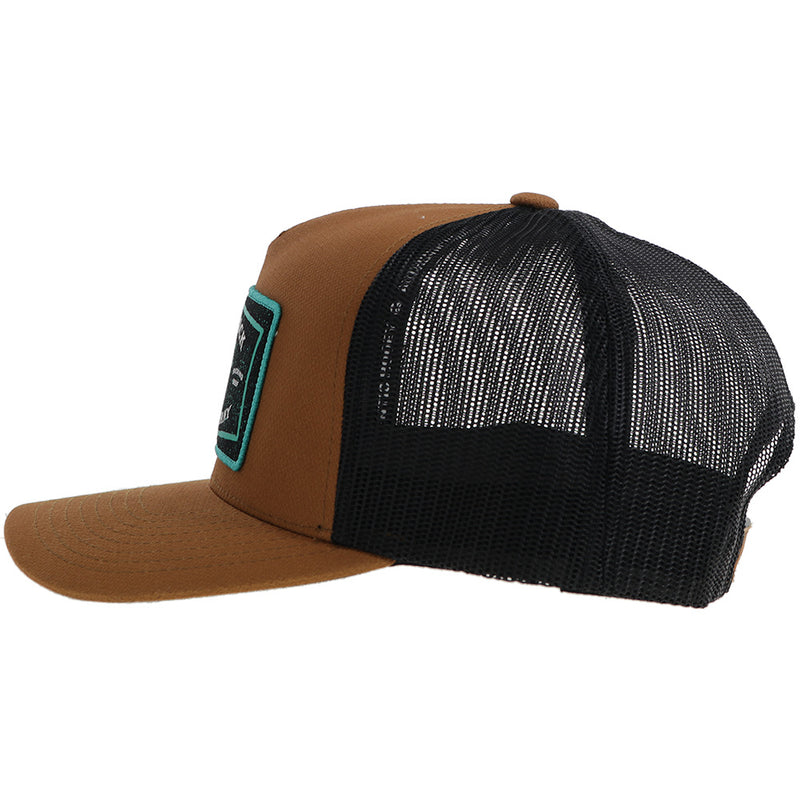 left side of the brown and black Hooey hat with turquoise, black, white rank stock rodeo company patch