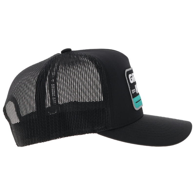 right side of black on black Gruene Hall hat with teal/black/white patch