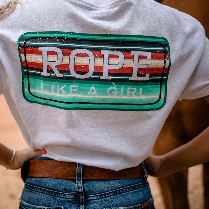 Bodega t-shirt in white with a teal and peach serape rope like a girl block logo on a model