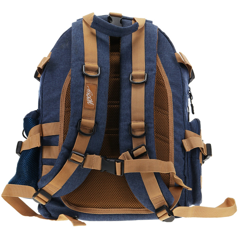 back of the mule denim back pack featuring brown details on the straps and back pad