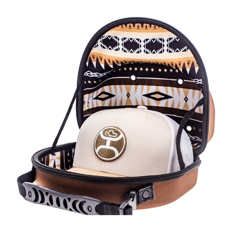 profile view of brown cap carrier with tan, black, brown Aztec pattern interior and gold cap inside
