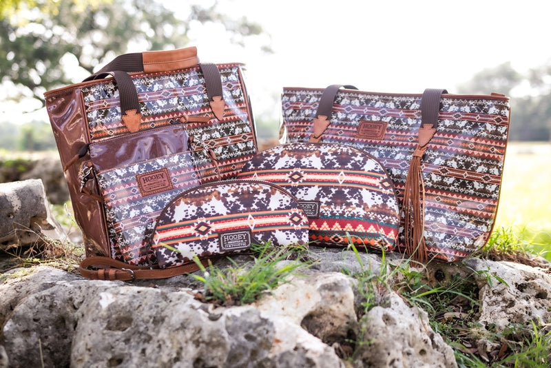 Hooey brown cow print with red, green, orange aztec print bag collection