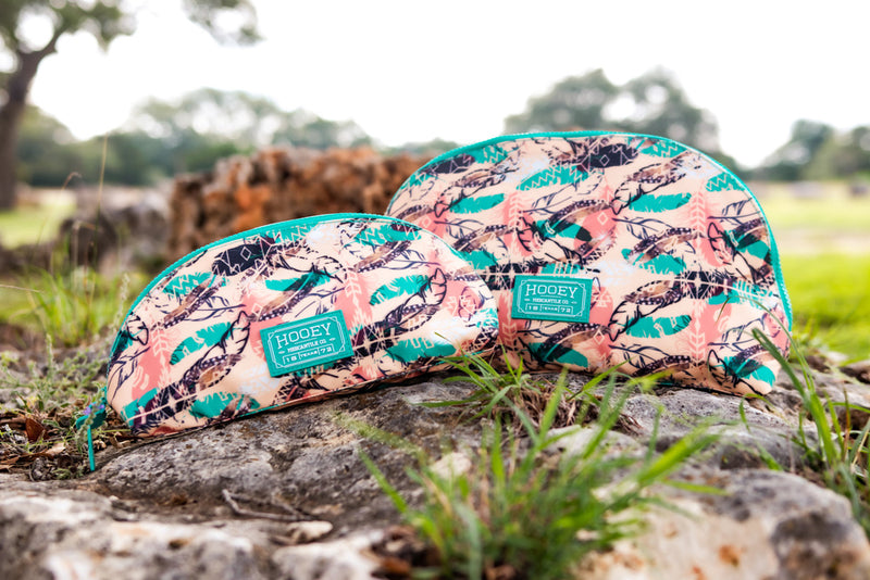 Hooey peach, teal, pink, black feather pattern cosmetic bag collection