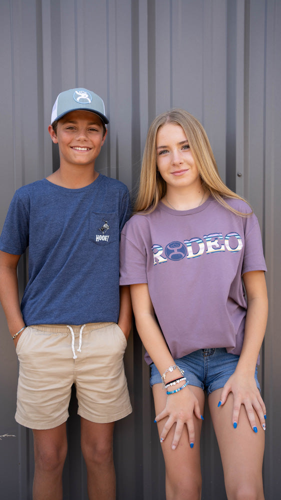 a pair of youth models wearing hooey youth gear