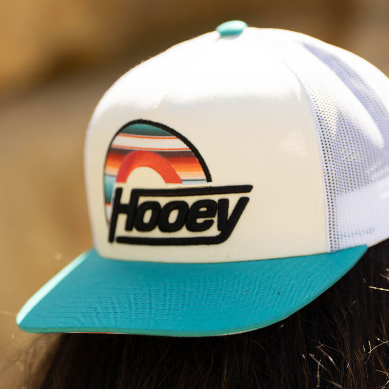 white and blue hooey hat with sunset pattern patch