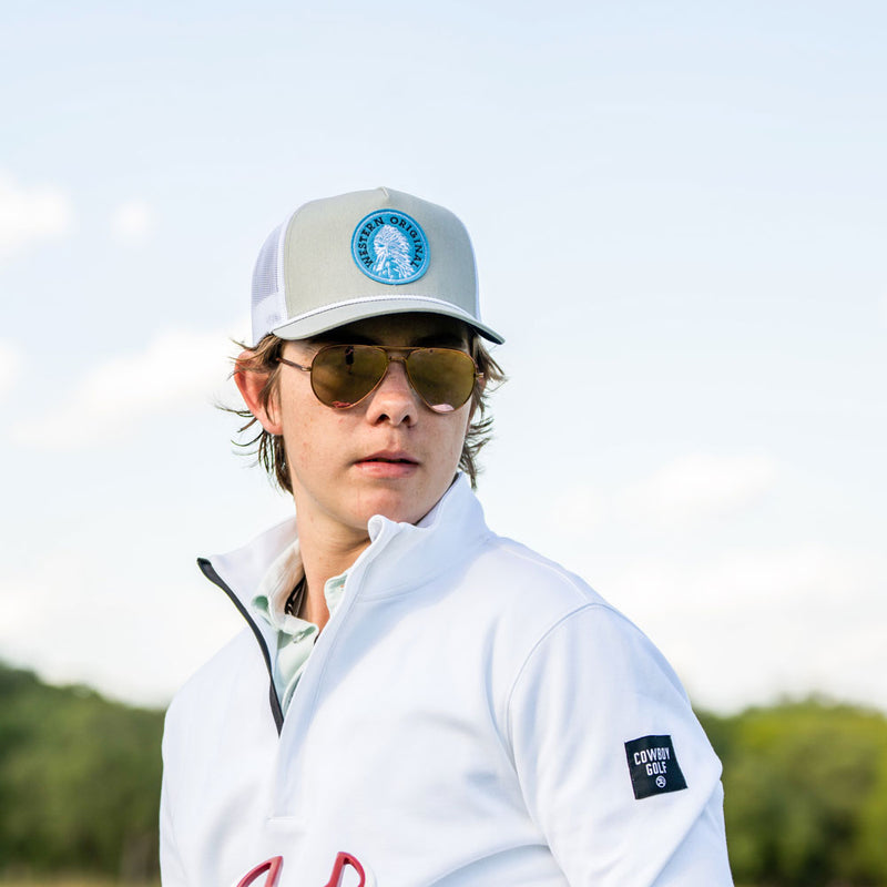 male model posing in hooey golf pullover and hat