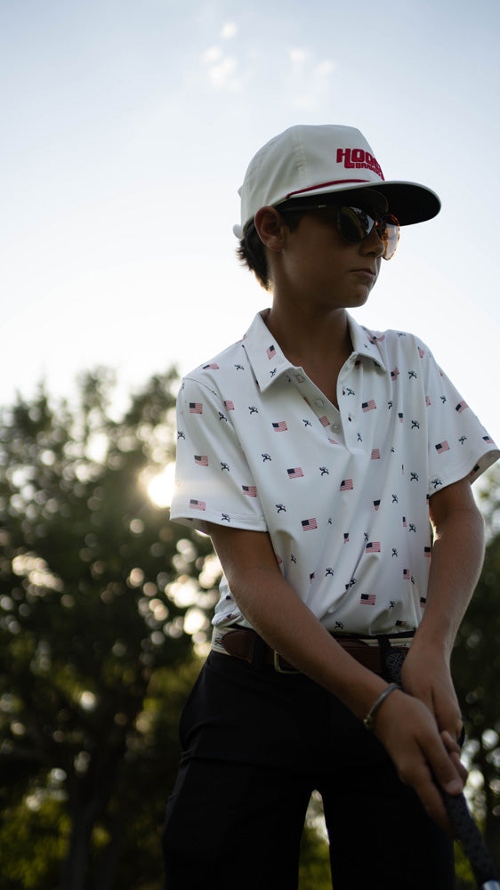 male model posing in Hooey golf polo with American flag pattern