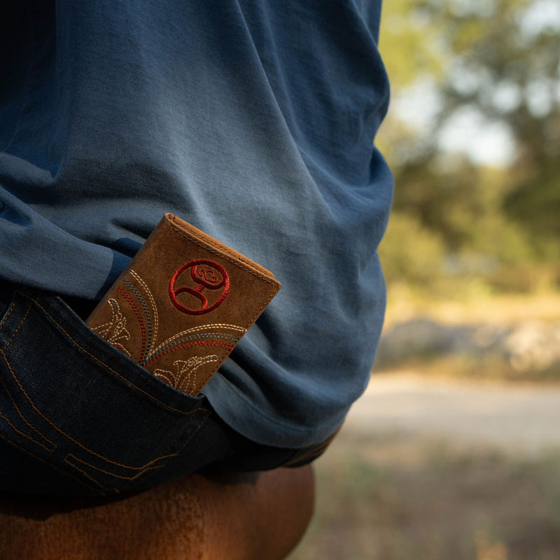 Ranger tan with embroidered accents rodeo bi-fold wallet in the back pocket of Hooey jeans