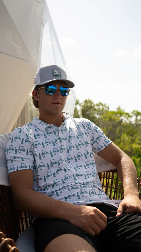 male model posing in grey and white Hooey golf hat and polo