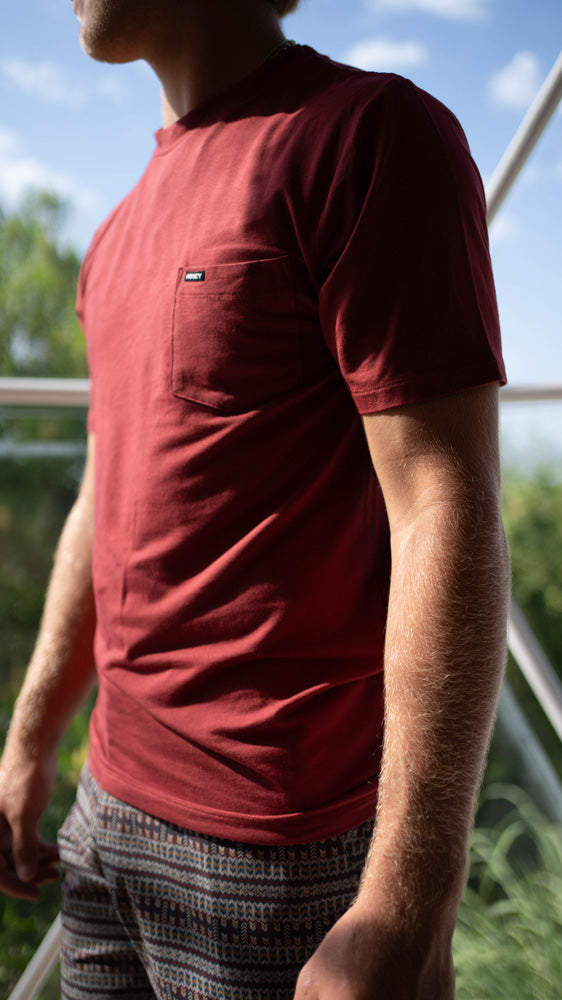 profile of male model wearing Hooey tee shirt and board shorts
