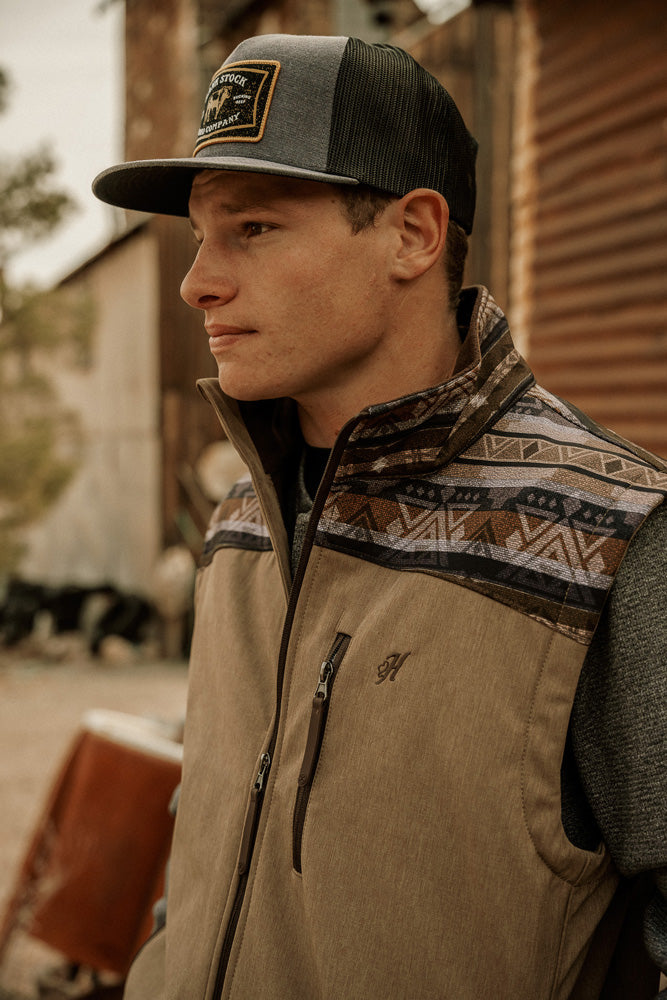 Profile photo of male model wearing gray and black rank stock Hooey hat tan vest with brown and gray Pattern On Shoulders And Collar
