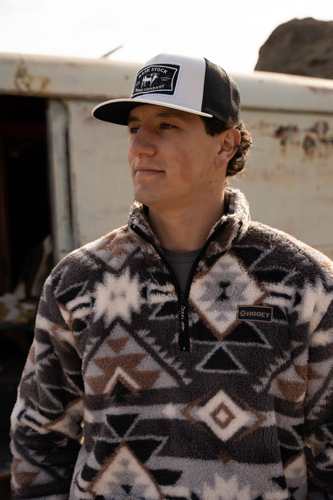 male model wearing aztec pattern grey pullover and grey and white rank stock hat