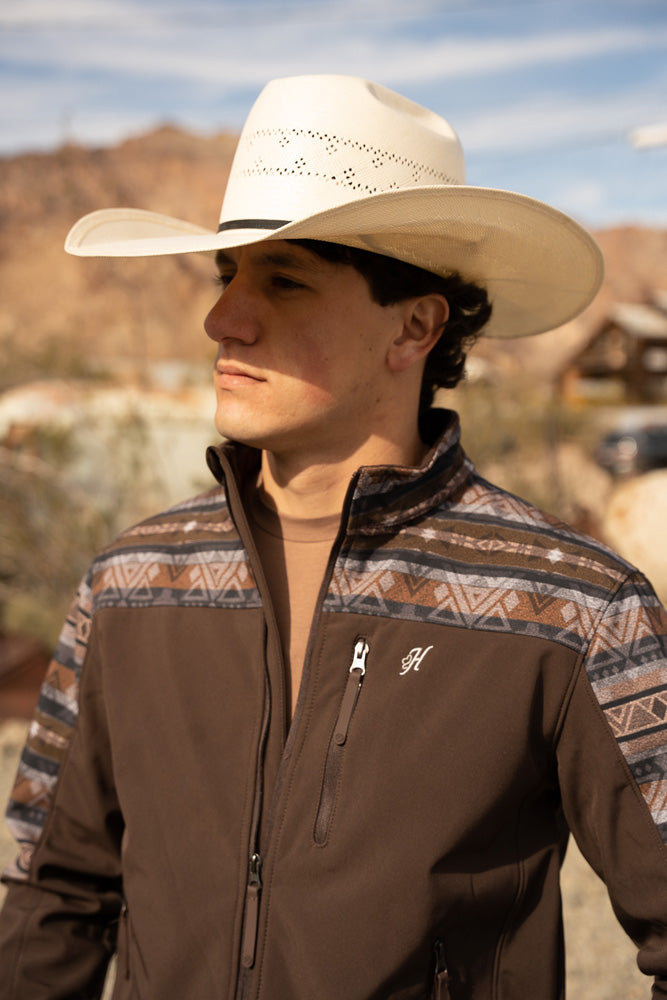 male model wearing straw cowboy hat and brown zipper jacket