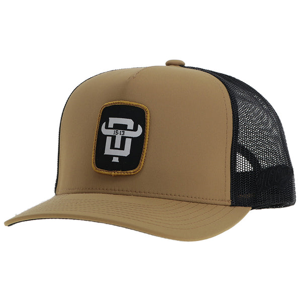 brown and black hat with black and white logo patch profile view