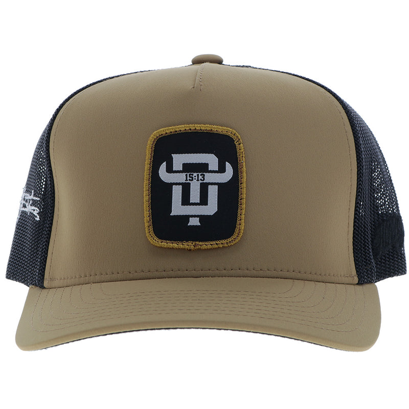 Dusty Tuckness hat in tan and black with a gold, black, and white DT logo patch