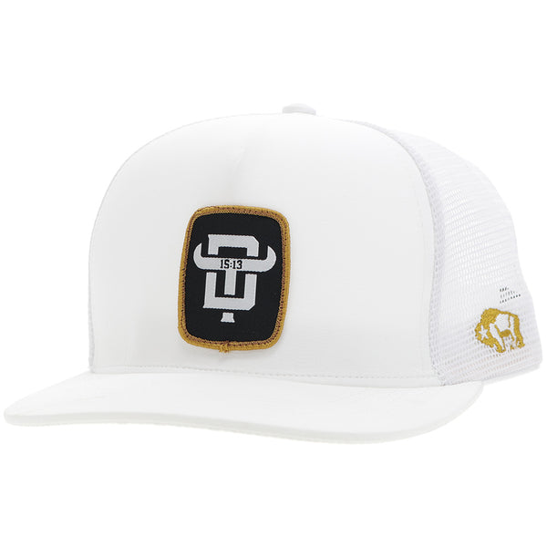profile of Dusty Tuckness all white hat with black and gold logo patch