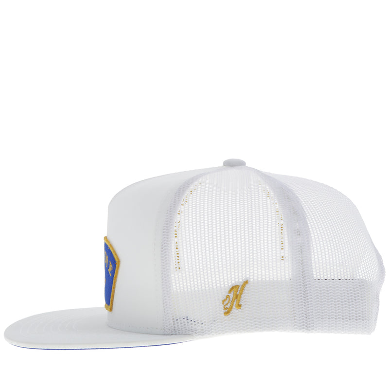 left side of white on white Gruene Hall hat with blue and gold patch