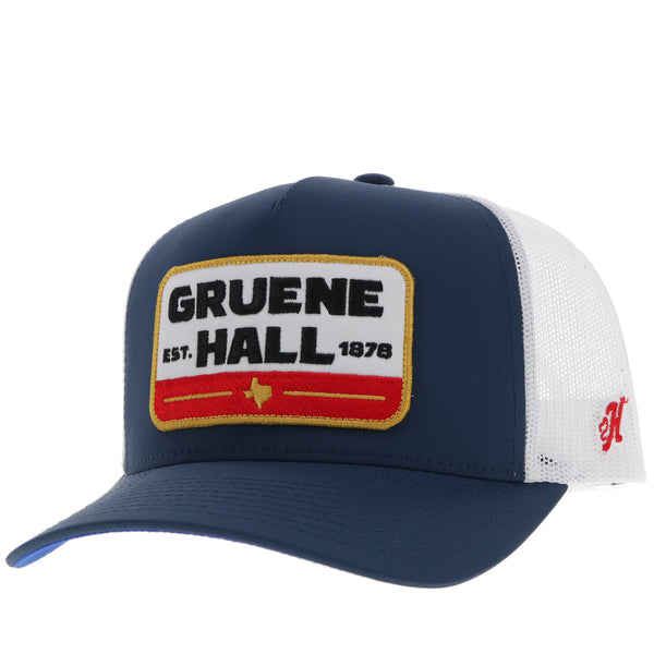 profile of navy and white Gruene Hall x Hooey hat with white, red, gold, black logo patch