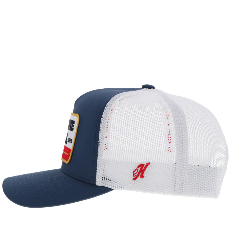 left side of navy and white Gruene Hall x Hooey hat with white, red, gold, black logo patch