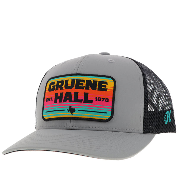 front of black and grey Gruene Hall hat with pink, yellow, teal serape patch
